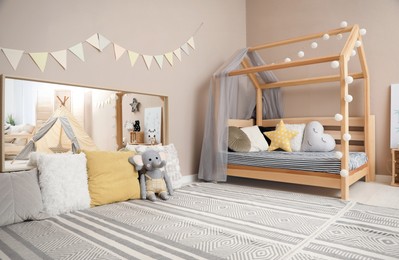 Stylish child room interior with comfortable floor bed