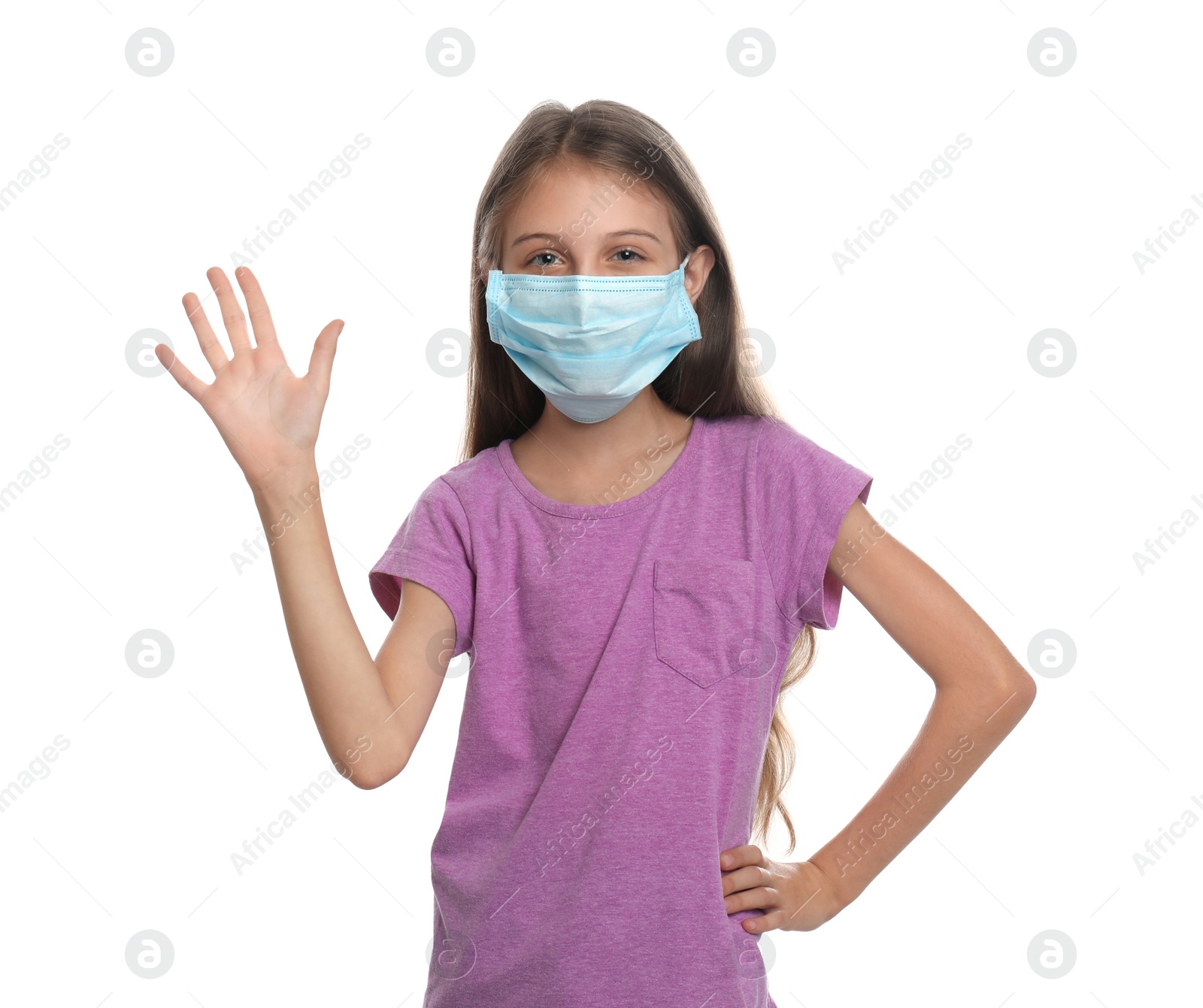 Photo of Little girl in protective mask showing hello gesture on white background. Keeping social distance during coronavirus pandemic