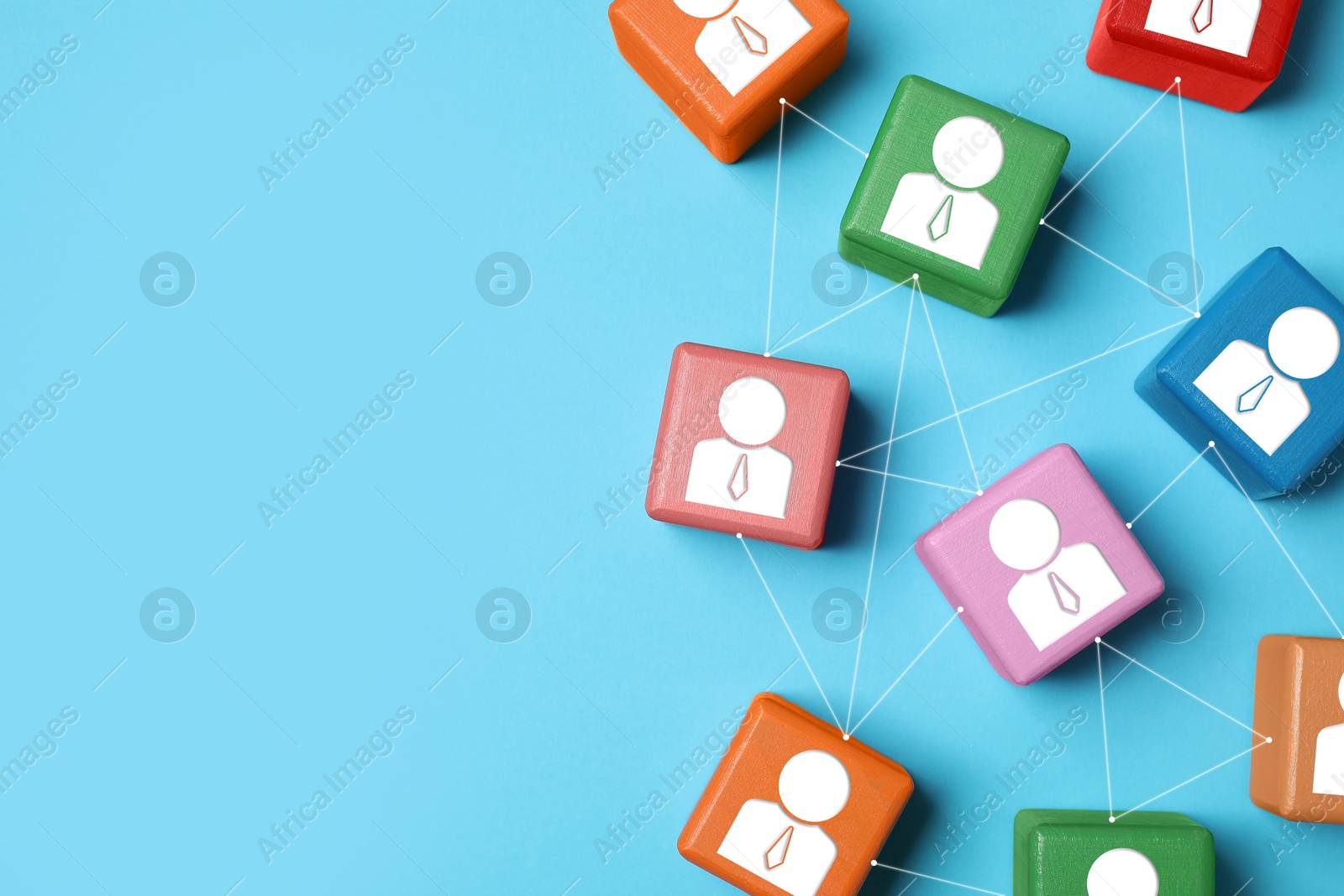 Image of Teamwork. Wooden cubes with human icons linked together symbolizing cooperation on light blue background, top view. Space for text