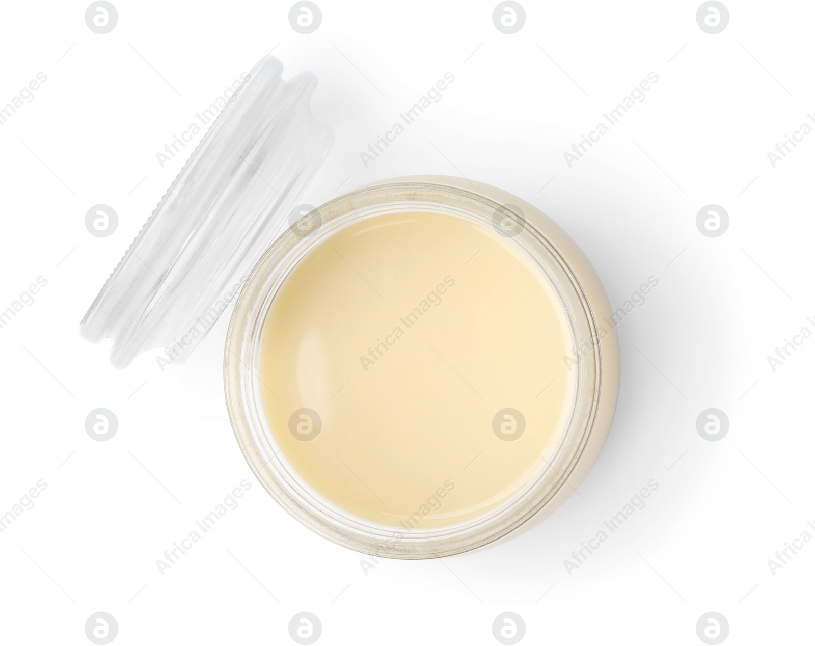 Photo of Open jar with condensed milk isolated on white, top view