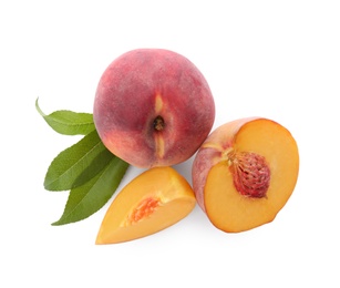 Photo of Whole and cut ripe peaches with leaves isolated on white, top view