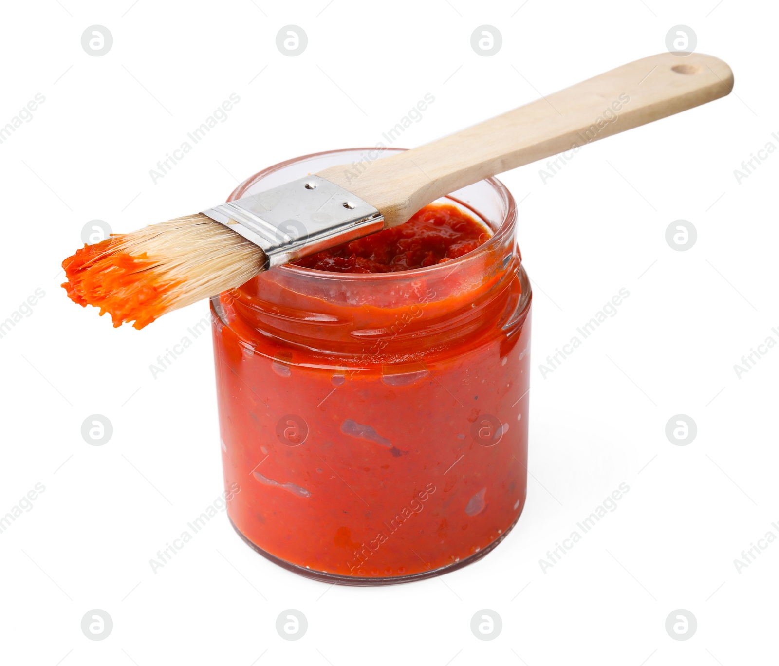 Photo of Fresh marinade in jar and basting brush isolated on white