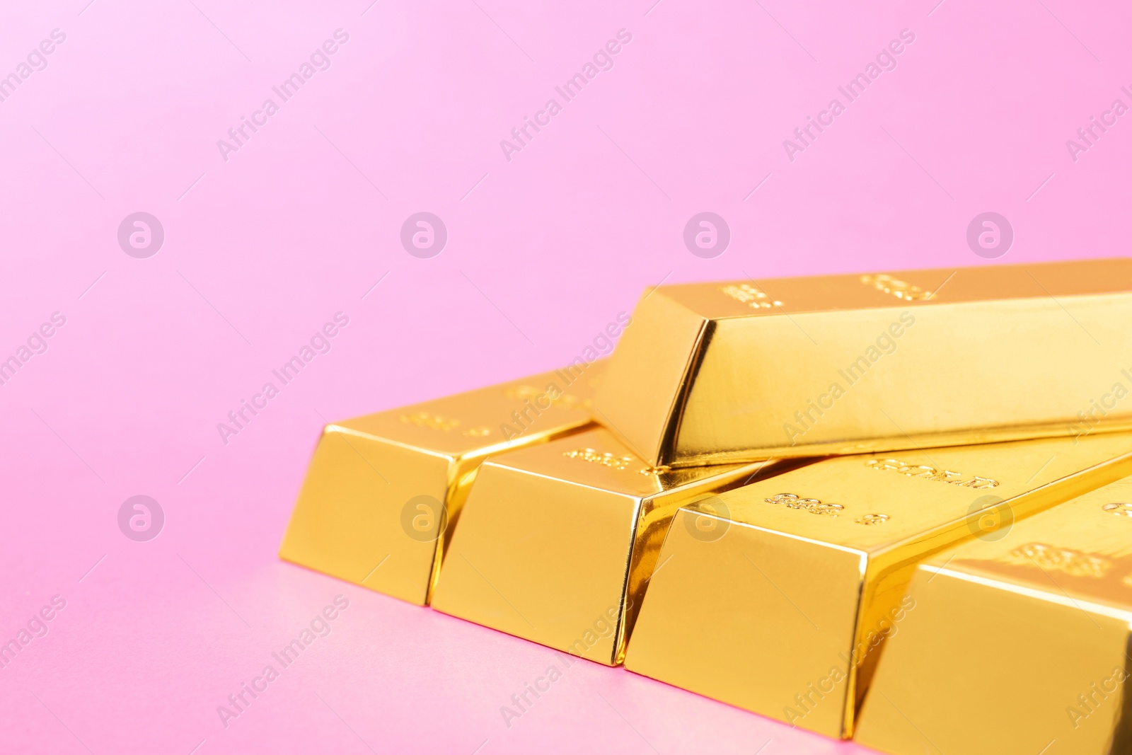 Photo of Precious shiny gold bars on color background. Space for text