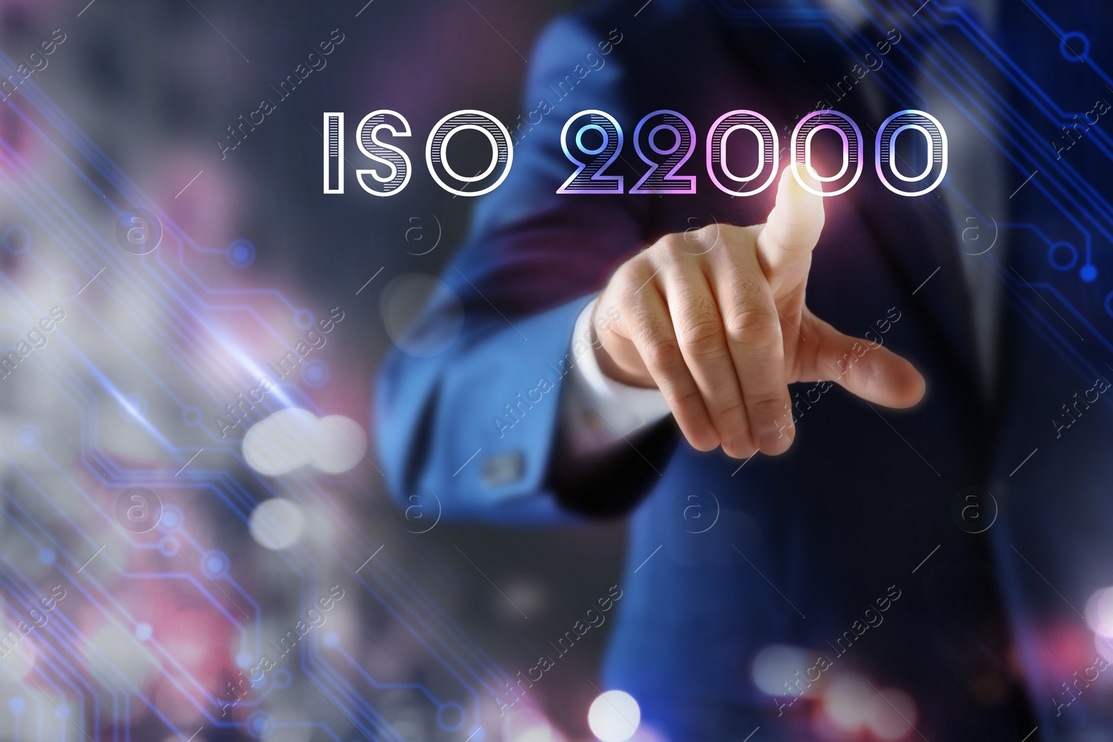 Image of Man pointing at virtual screen with text ISO 22000, closeup