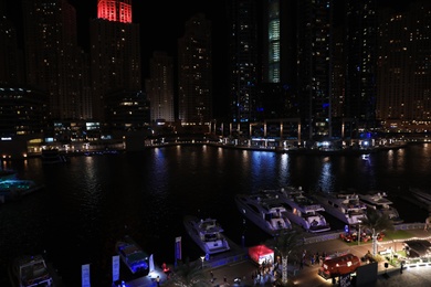 DUBAI, UNITED ARAB EMIRATES - NOVEMBER 03, 2018: Night cityscape of marina district with moored yachts