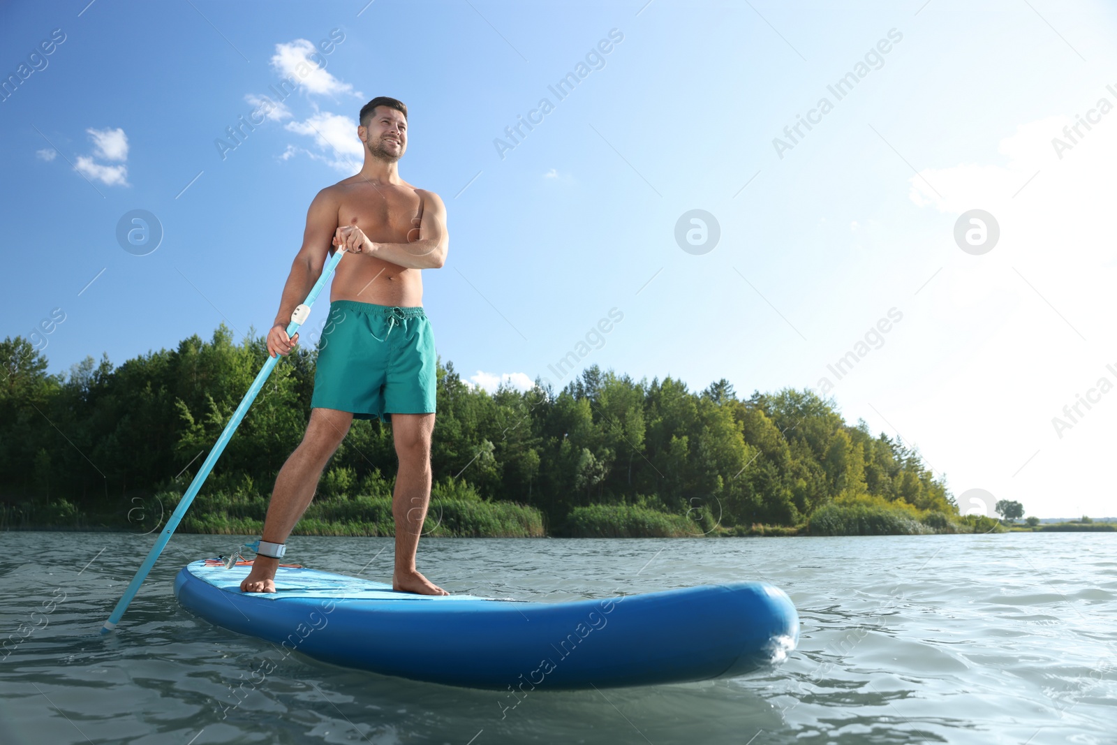 Photo of Man paddle boarding on SUP board in river