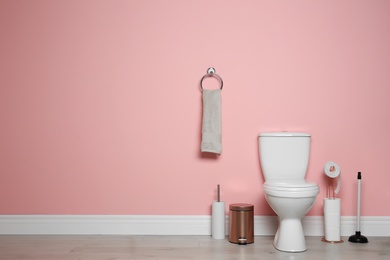 New ceramic toilet bowl in modern bathroom with space for text