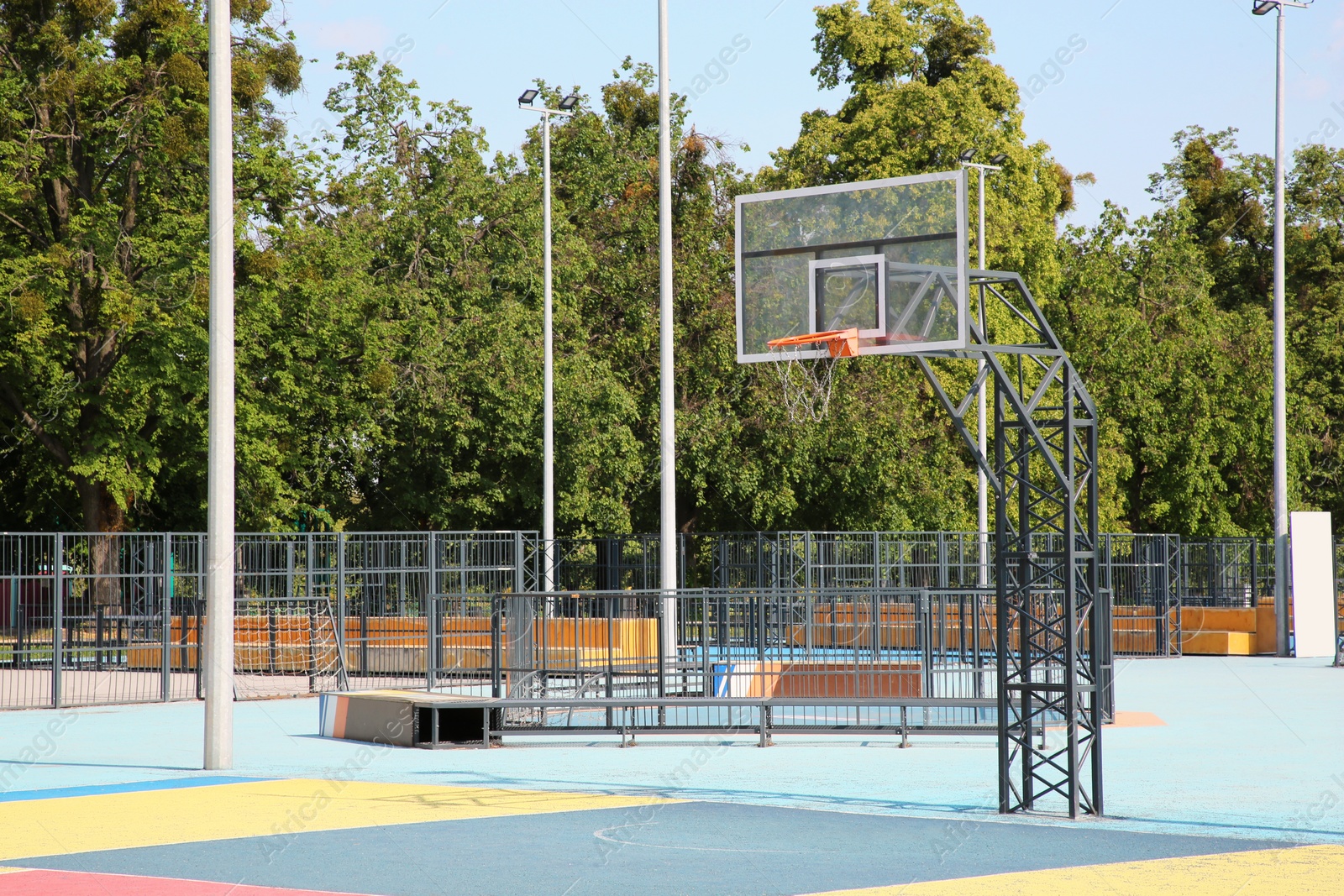 Photo of Empty basketball court with backboard outdoors on sunny day