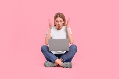 Photo of Emotional woman with laptop on pink background