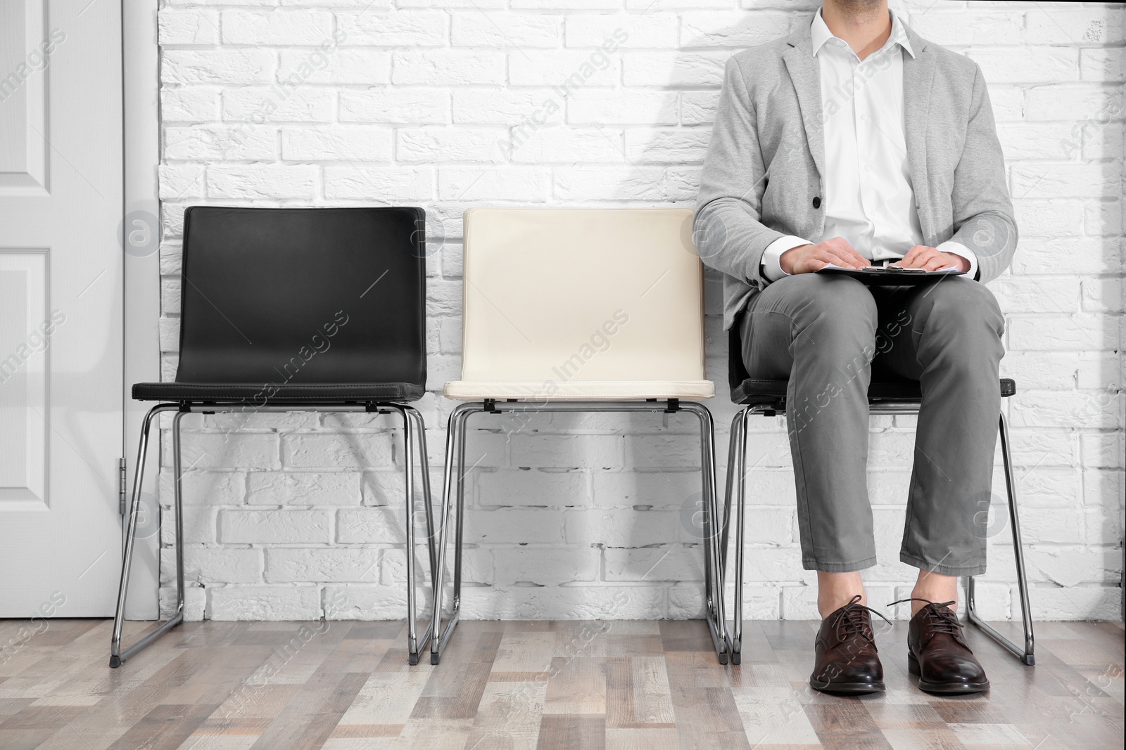 Photo of Young man waiting for job interview, indoors