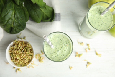 Green buckwheat smoothie on white wooden table, top view