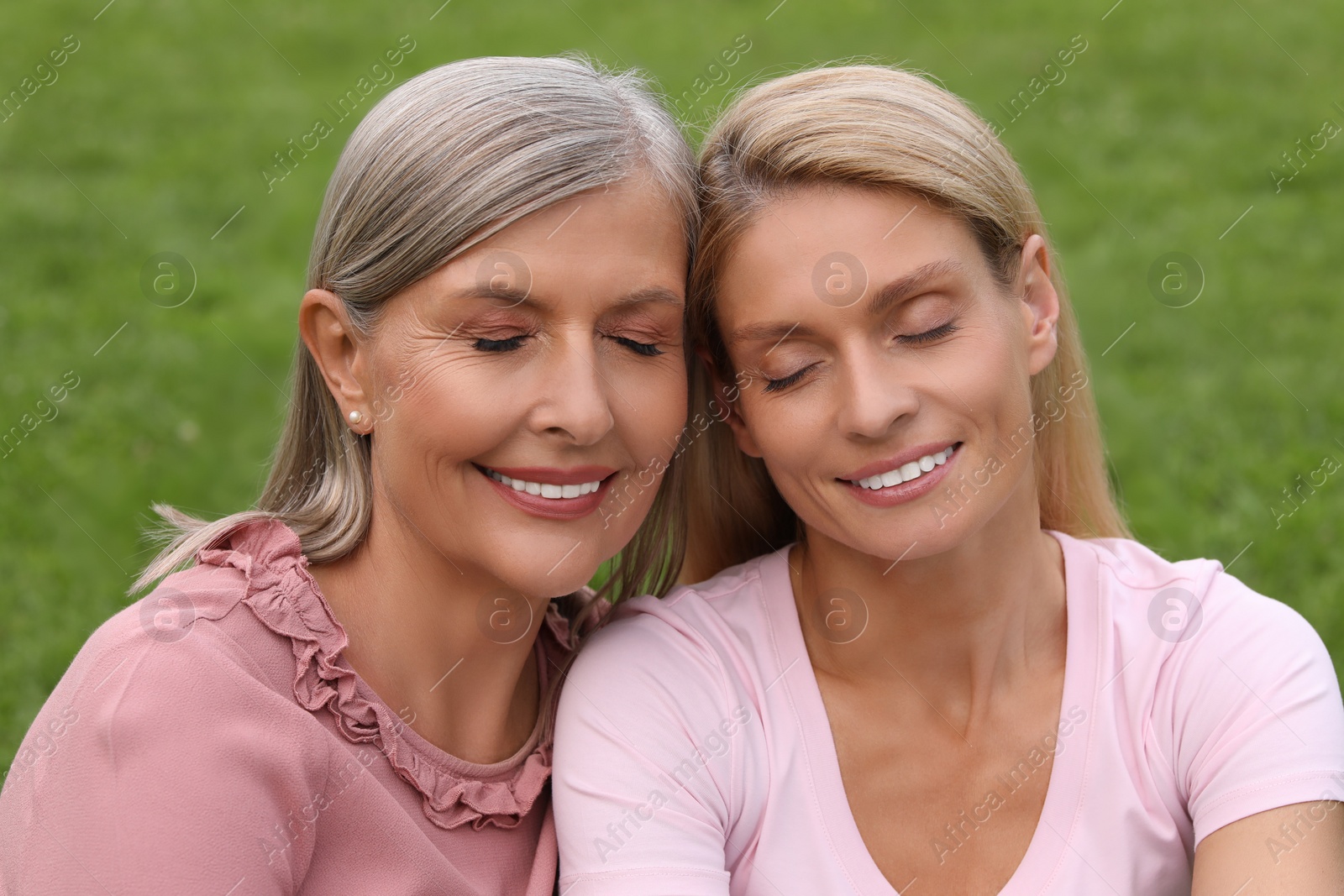 Photo of Happy mature mother and her daughter outdoors