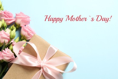 Happy Mother's Day greeting card. Beautiful flowers and gift box on light blue background