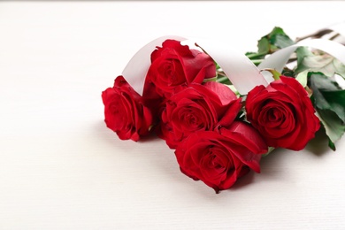 Beautiful red roses on white table. Valentine's Day celebration