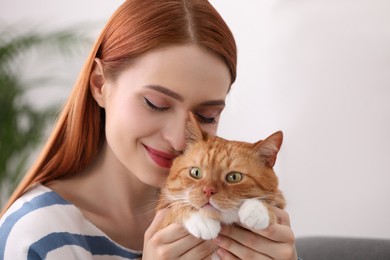 Photo of Woman with her cute cat at home