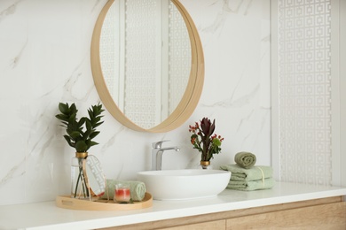 Modern bathroom interior with stylish mirror and vessel sink