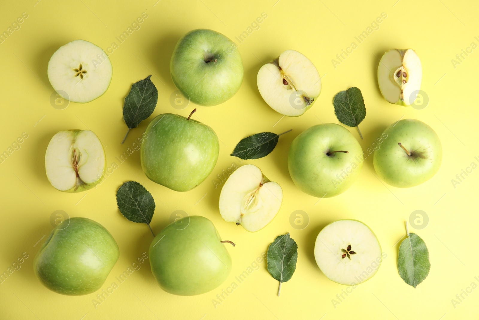 Photo of Flat lay composition of fresh ripe green apples on yellow background