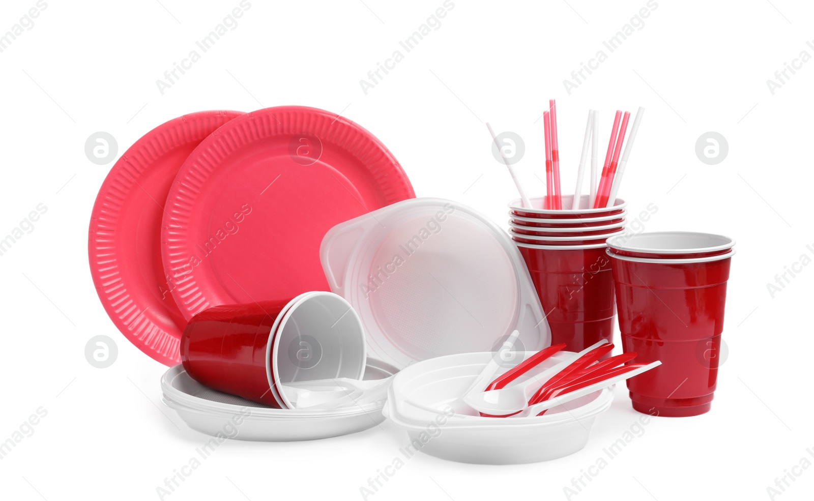 Photo of Set of bright disposable tableware on white background