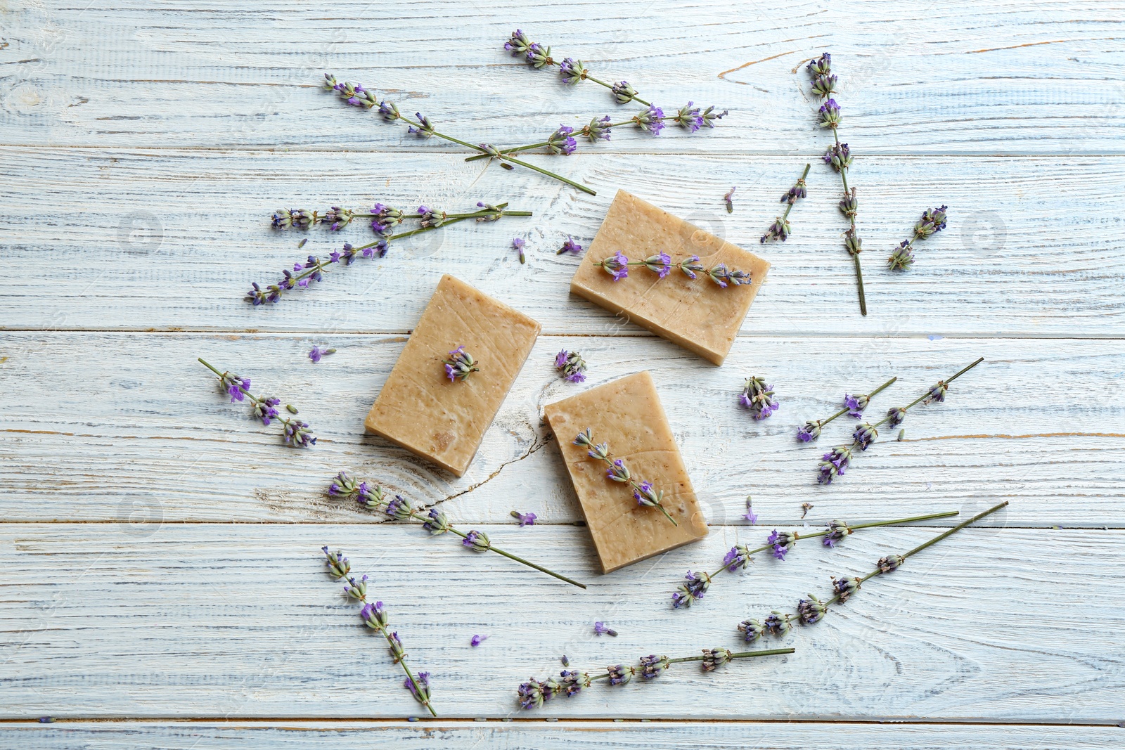 Photo of Flat lay composition of handmade soap bars with lavender flowers on white wooden background