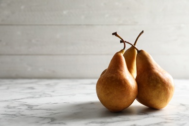 Ripe pears on marble table. Space for text