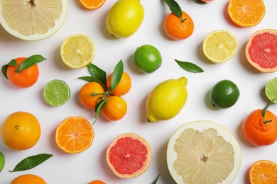 Different citrus fruits on white background, flat lay