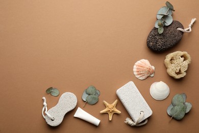 Flat lay composition with pumice stones on brown background. Space for text