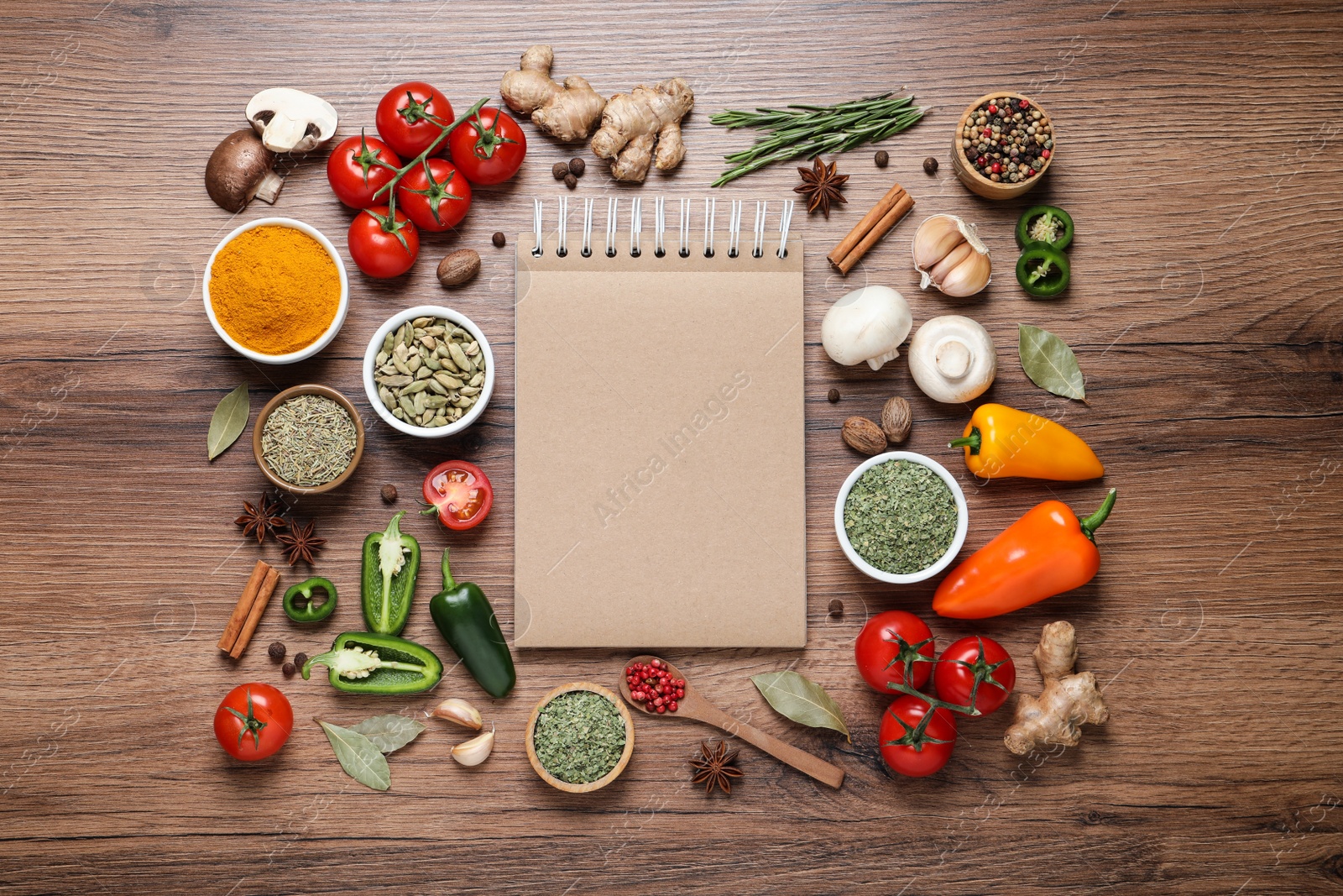 Photo of Open recipe book and different ingredients on wooden table, flat lay. Space for text