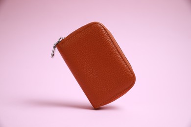 Photo of Stylish brown leather purse on pink background