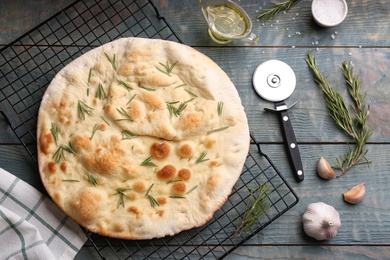 Flat lay composition with focaccia bread on blue wooden table