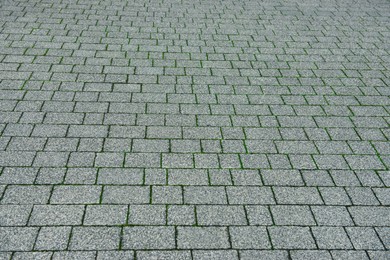 Photo of View on grey stone sidewalk. Footpath covering