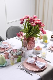 Festive table setting with beautiful flowers. Easter celebration