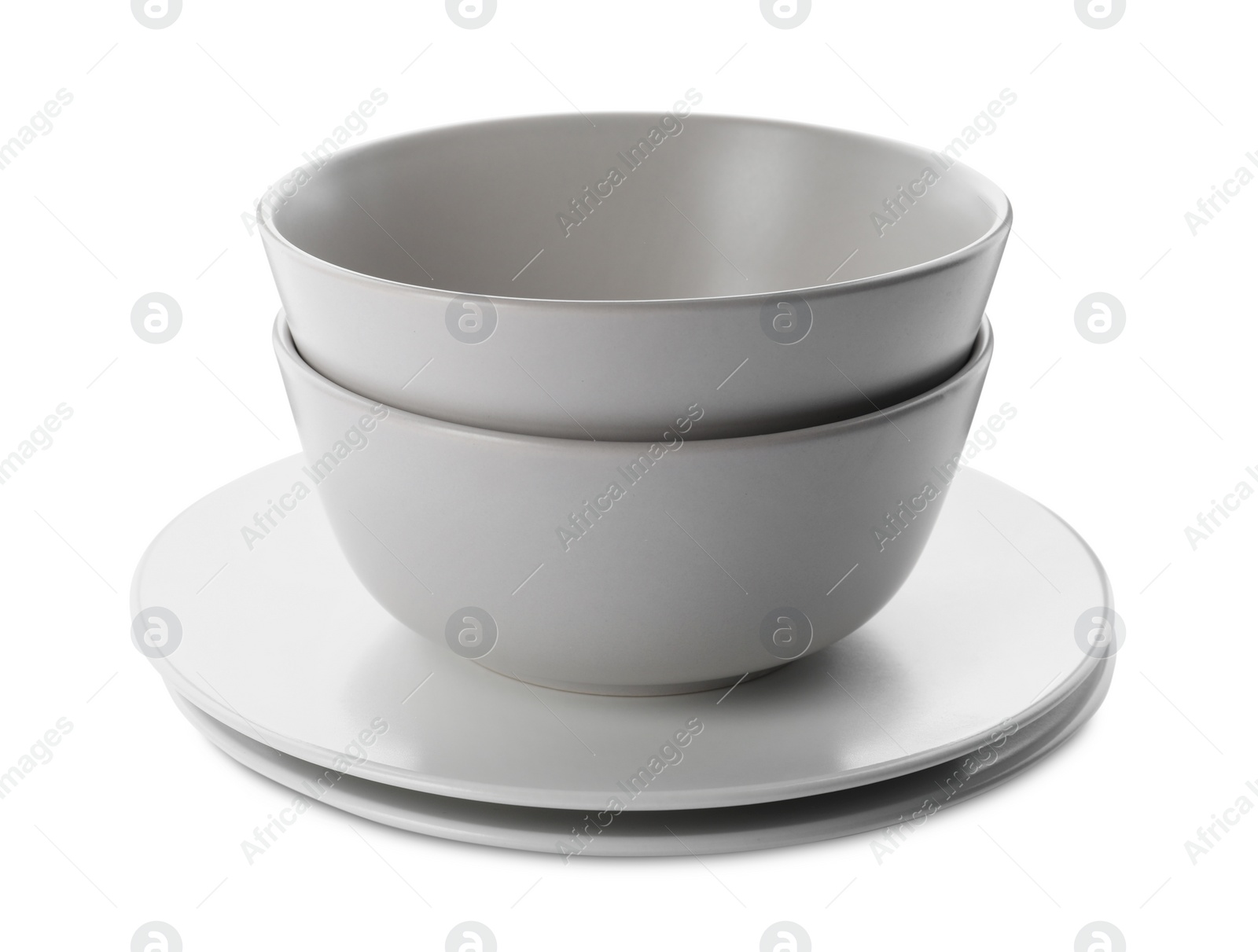 Photo of Stack of clean plates and bowls on white background