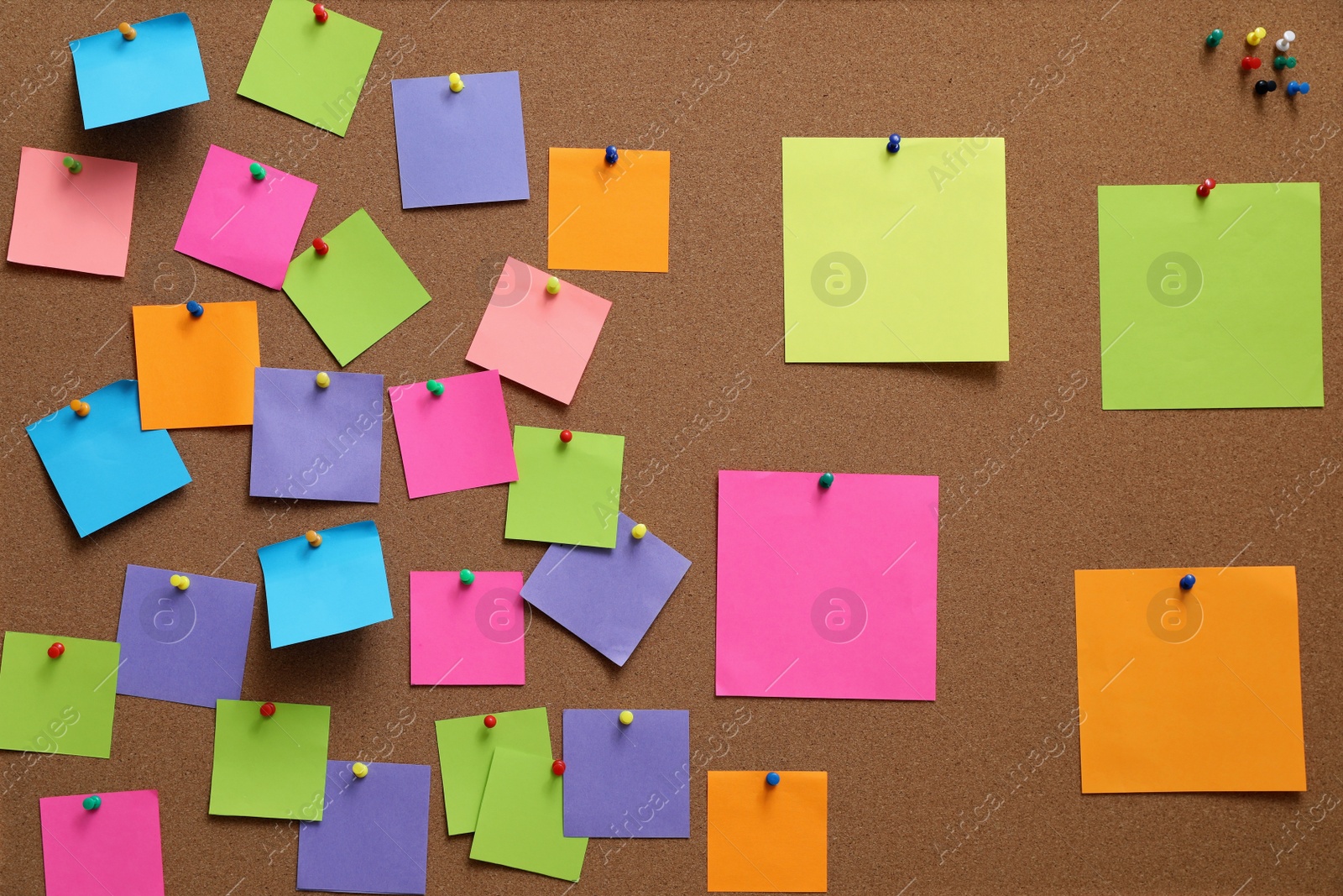 Photo of Many blank colorful notes pinned to corkboard