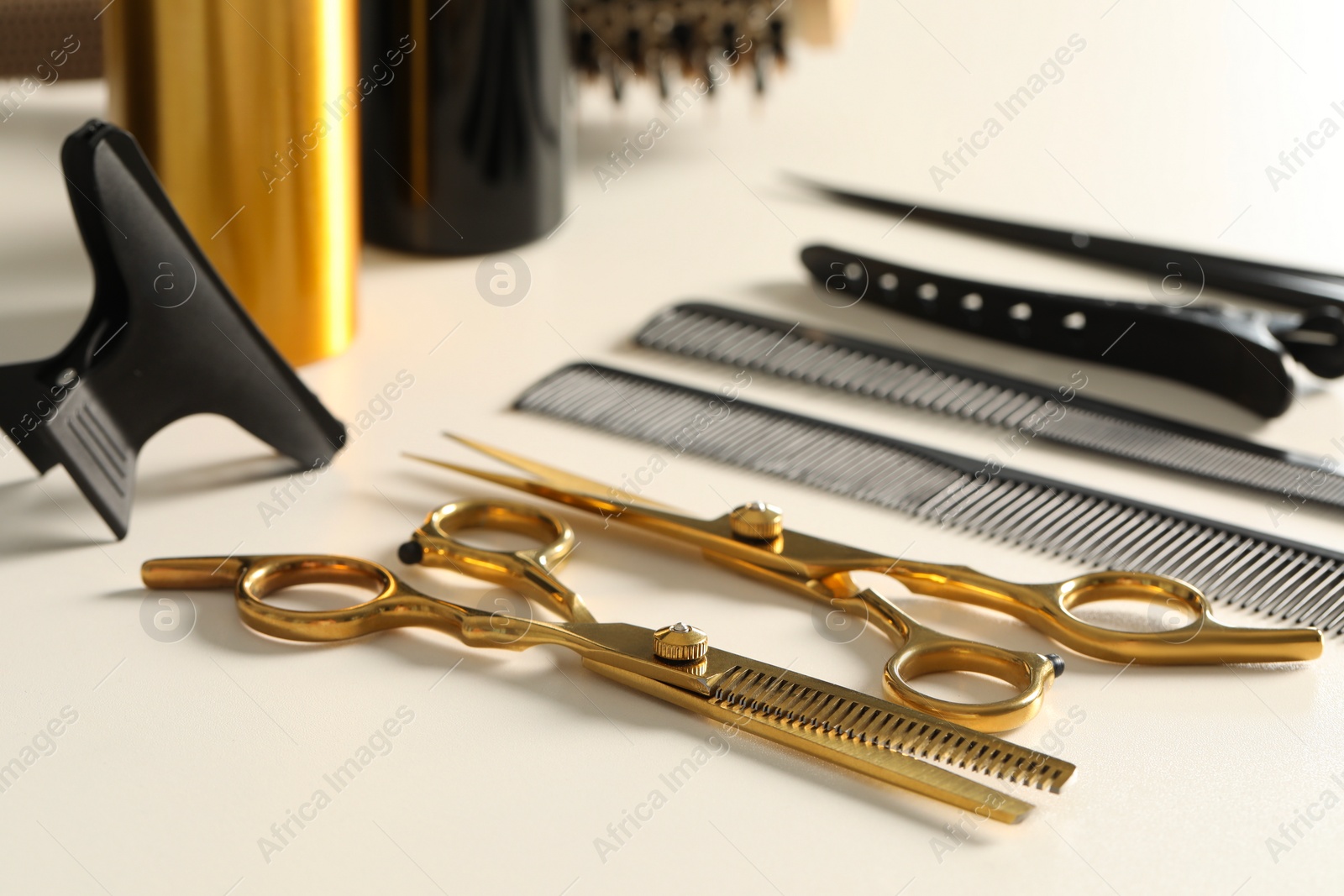 Photo of Hairdresser tools. Different scissors and combs on white table, closeup