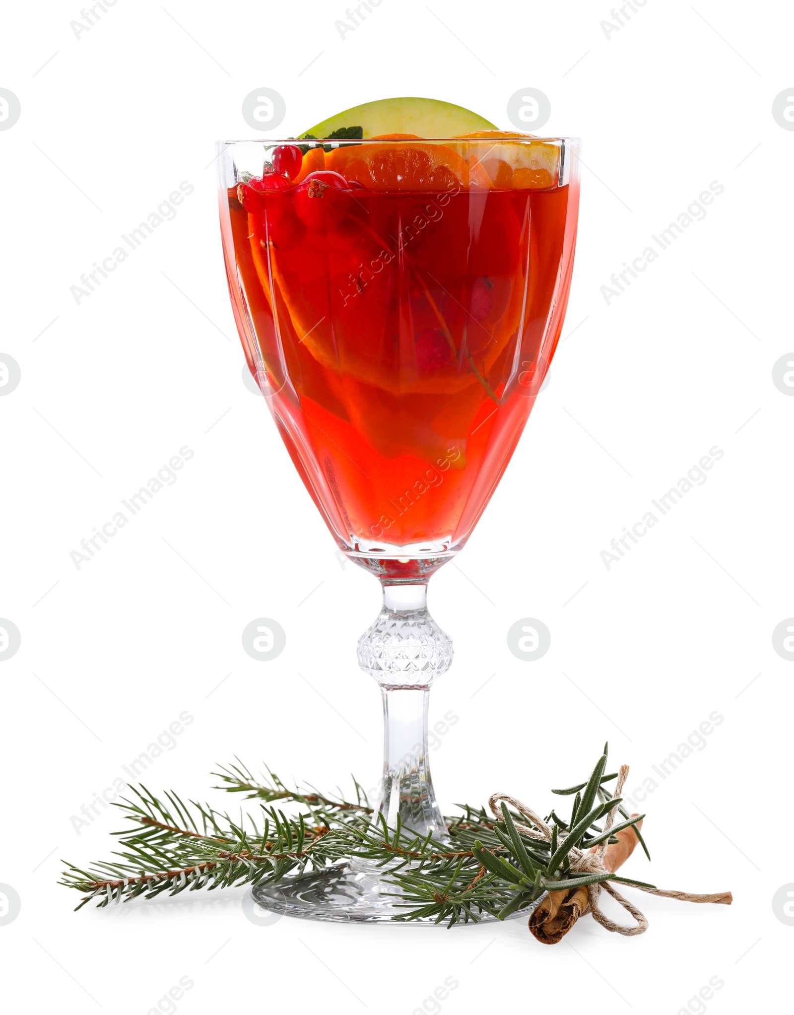 Photo of Christmas Sangria cocktail in glass, cinnamon stick and fir tree branch isolated on white