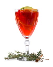 Photo of Christmas Sangria cocktail in glass, cinnamon stick and fir tree branch isolated on white