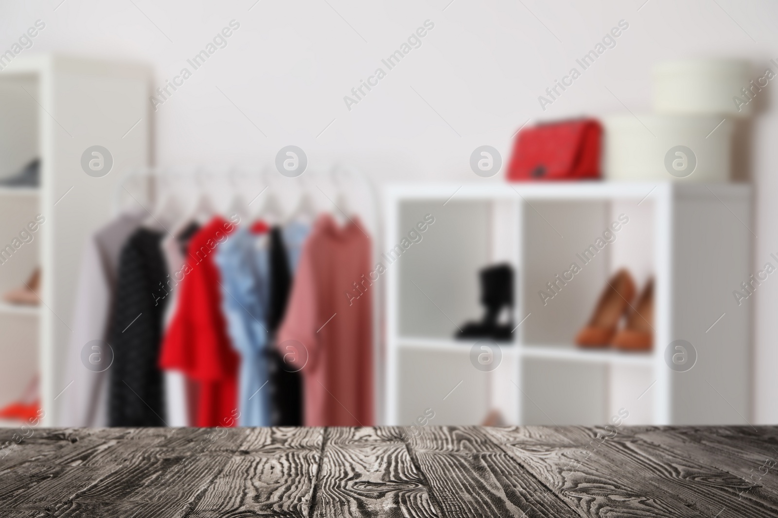 Image of Empty wooden surface and blurred view of shoes store, space for text 