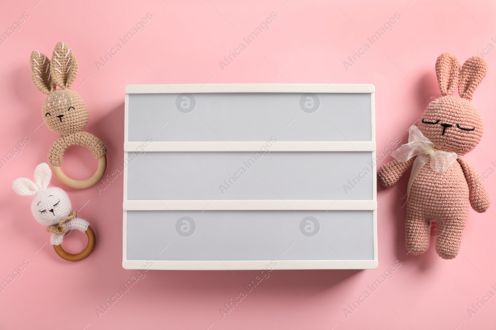 Photo of Blank letter board and different toys on pink background, flat lay. Mockup for design