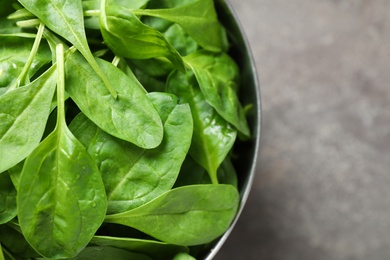 Photo of Fresh green healthy spinach on grey table, top view