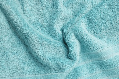 Photo of Soft crumpled light blue towel as background, top view