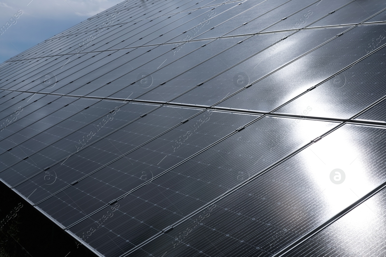 Photo of Solar panels installed outdoors, closeup. Alternative energy source