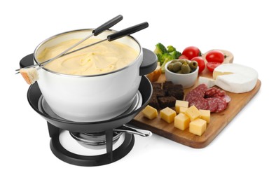 Photo of Fondue with tasty melted cheese, forks and different snacks isolated on white