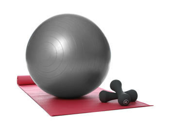 Photo of Fitness ball, dumbbells and yoga mat isolated on white