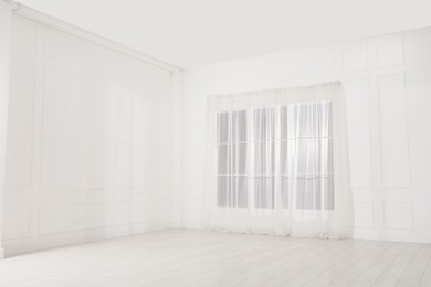 Photo of Empty room with white walls and large window