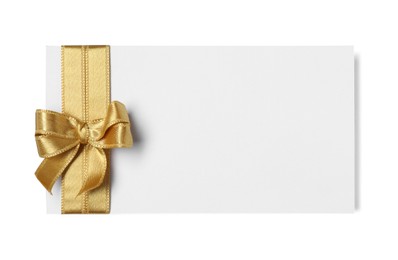 Blank gift card with golden bow isolated on white, top view