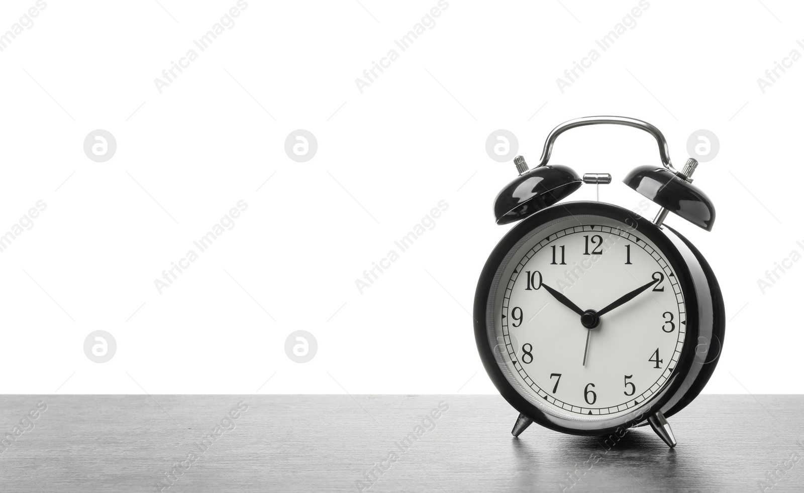 Photo of Alarm clock on table against white background. Time concept