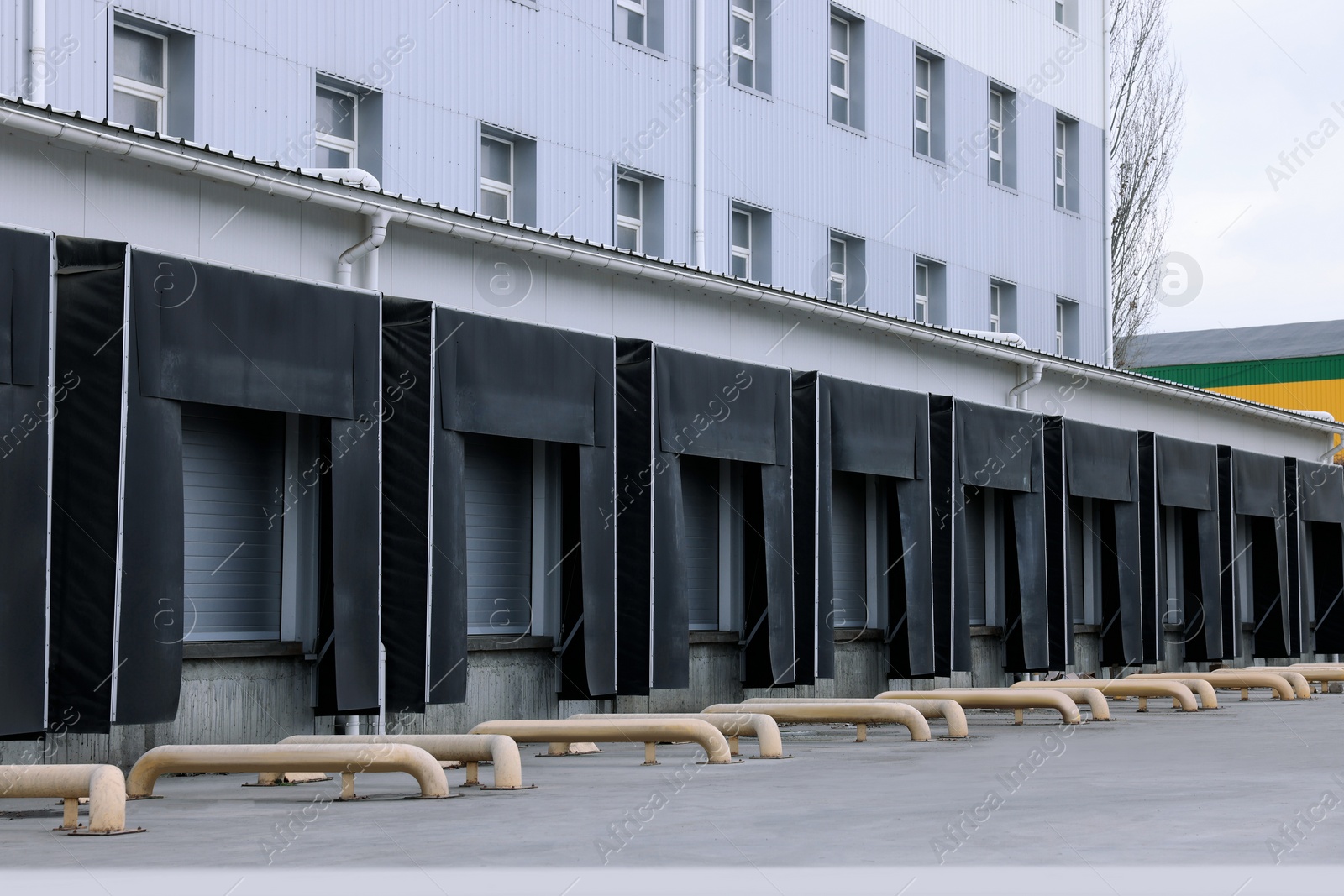 Image of Warehouse with loading docks outdoors. Logistics center