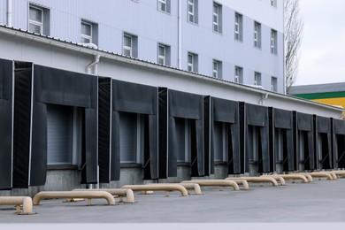 Image of Warehouse with loading docks outdoors. Logistics center