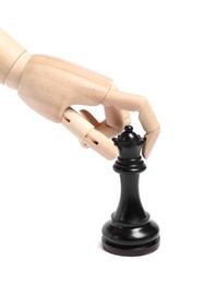 Photo of Robot with black chess piece isolated on white. Wooden hand representing artificial intelligence