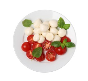 Plate of delicious Caprese salad with tomatoes, mozzarella and basil isolated on white, top view